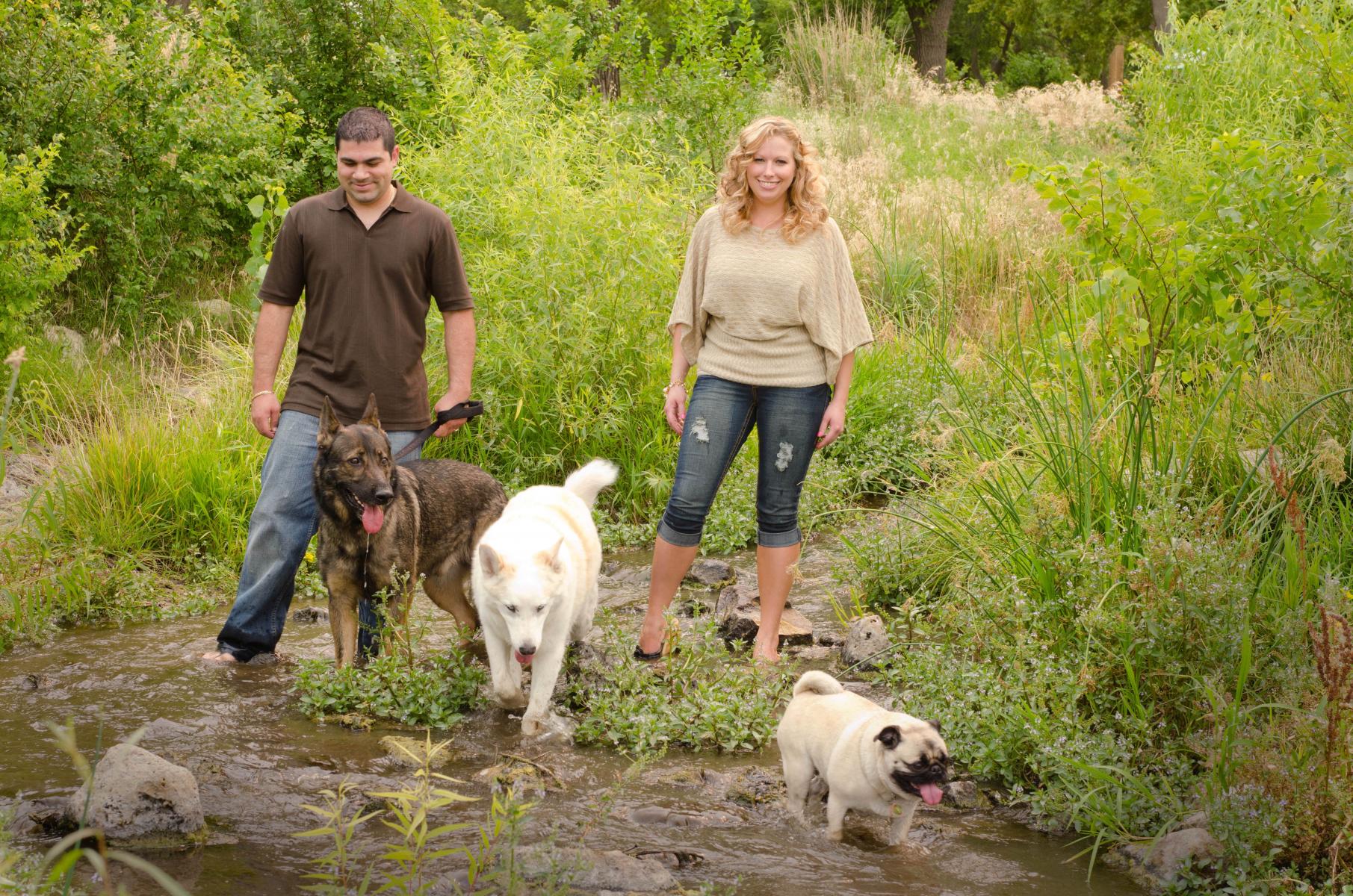 Walking in a brook, free, with their pets was one of Cisneros's requests for their candid family portrait, by Robertsons' Warehouse Photography, Wichita, KS