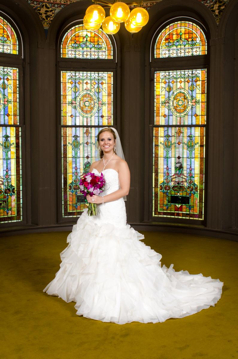This enchanting bridal portrait is composed of a beautiful bride and beautiful stainglass, by Robertsons' Warehouse Photography, Wichita, KS