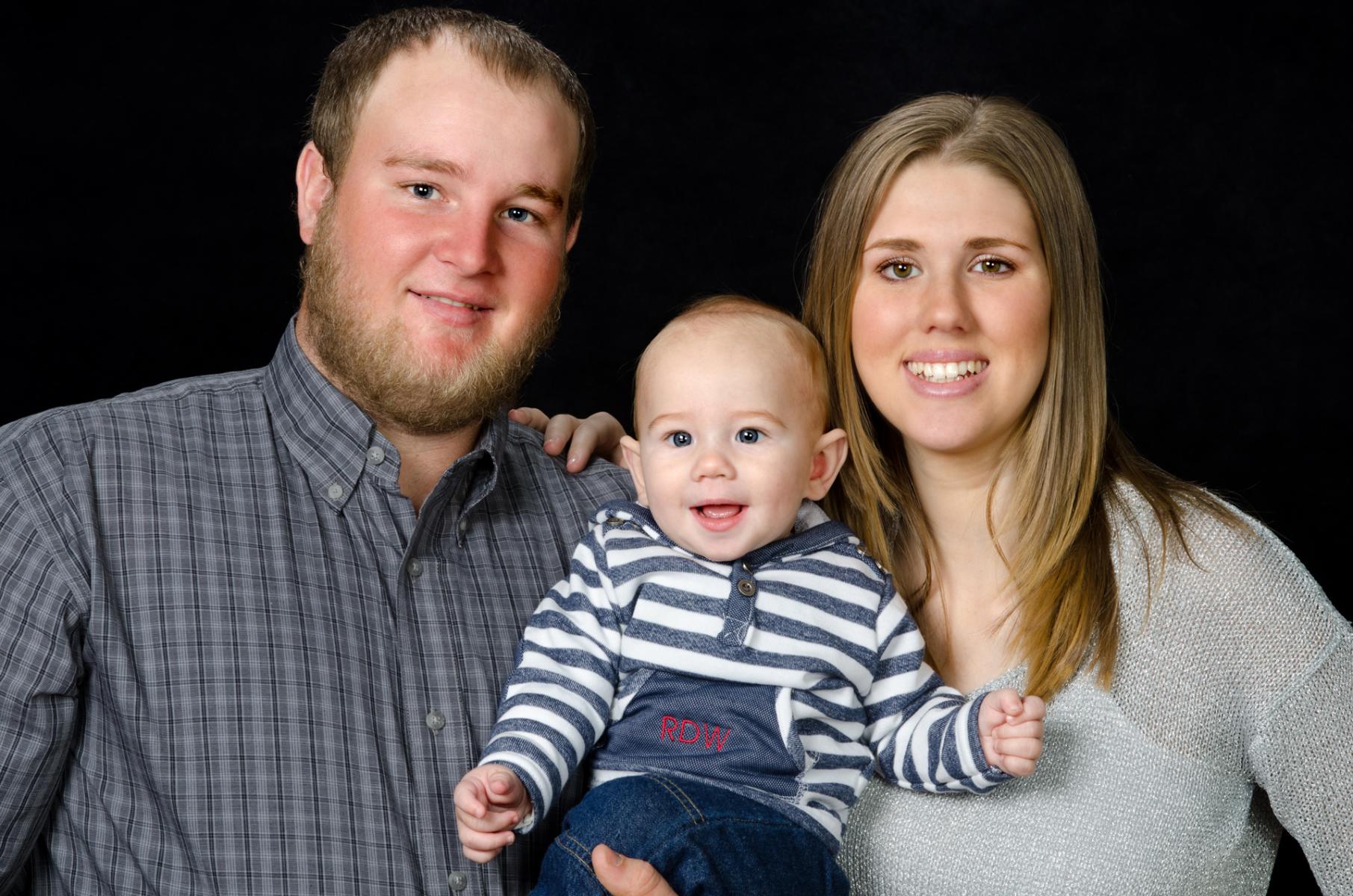 Timeless family portrait on a black background of Will, Ryder and Savannah, by Robertsons' Warehouse Photography, Wichita, KS
