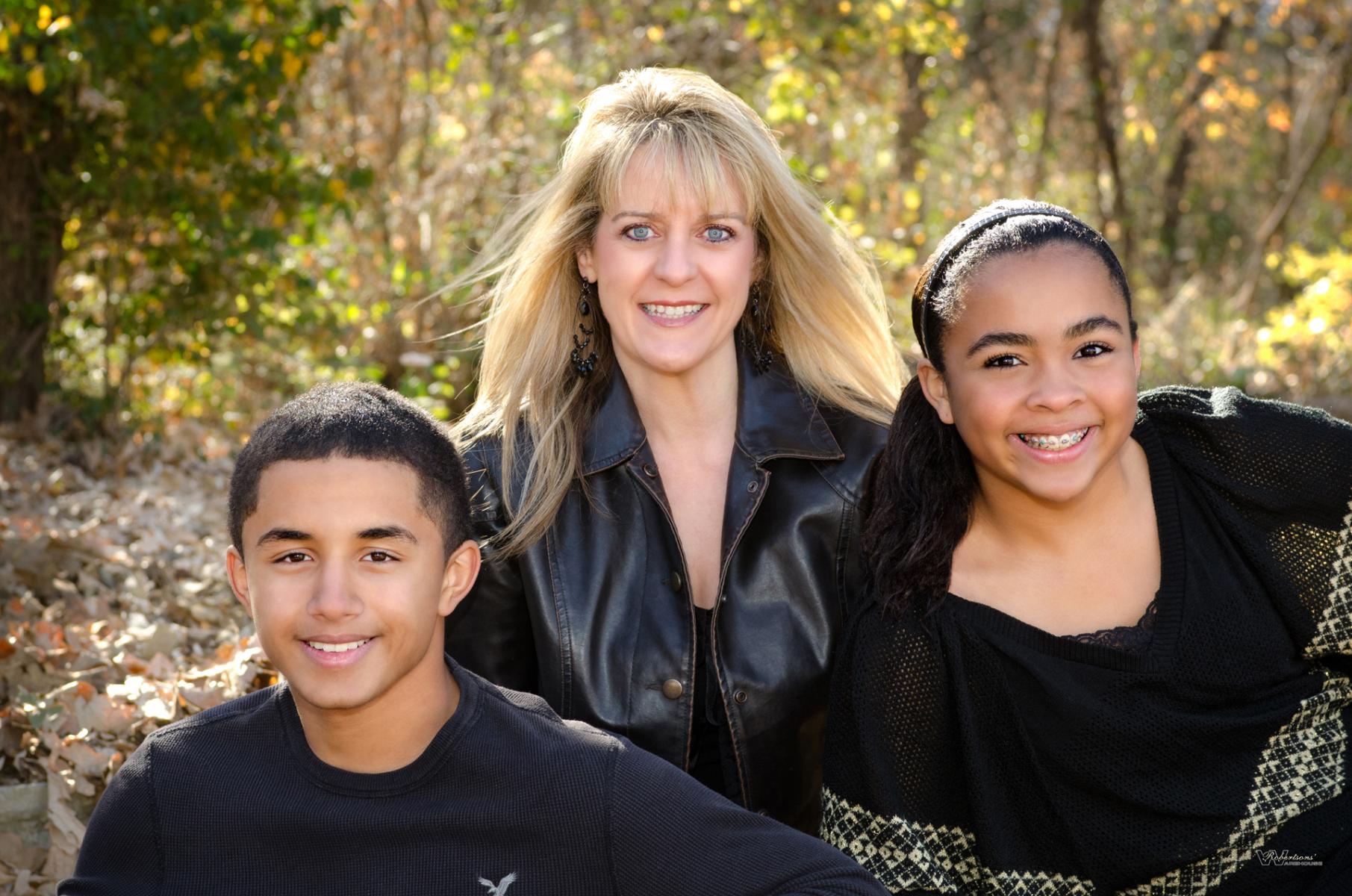 Striking close-up photo of Kay Baker with her teenagers photographed in a Wichita park, by Robertsons' Warehouse Photography, Wichita, KS