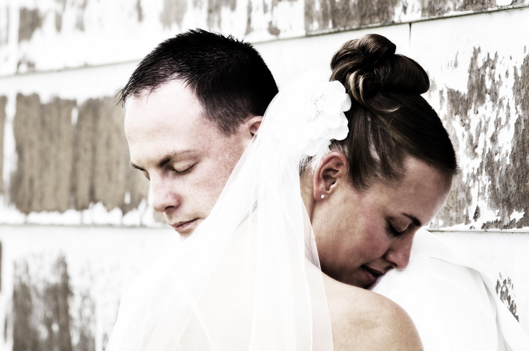 Zoomed in on a tender moment to heighten the emotional impact of this wedding picture, by Robertsons' Warehouse Photography, Wichita, KS