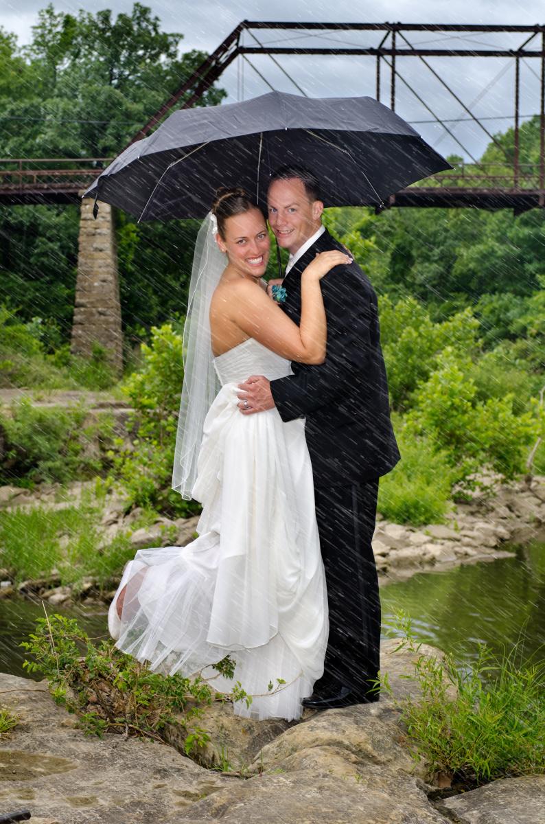 Rain heightens the emotional bond between two people enjoying each other's company, by Robertsons' Warehouse Photography, Wichita, KS