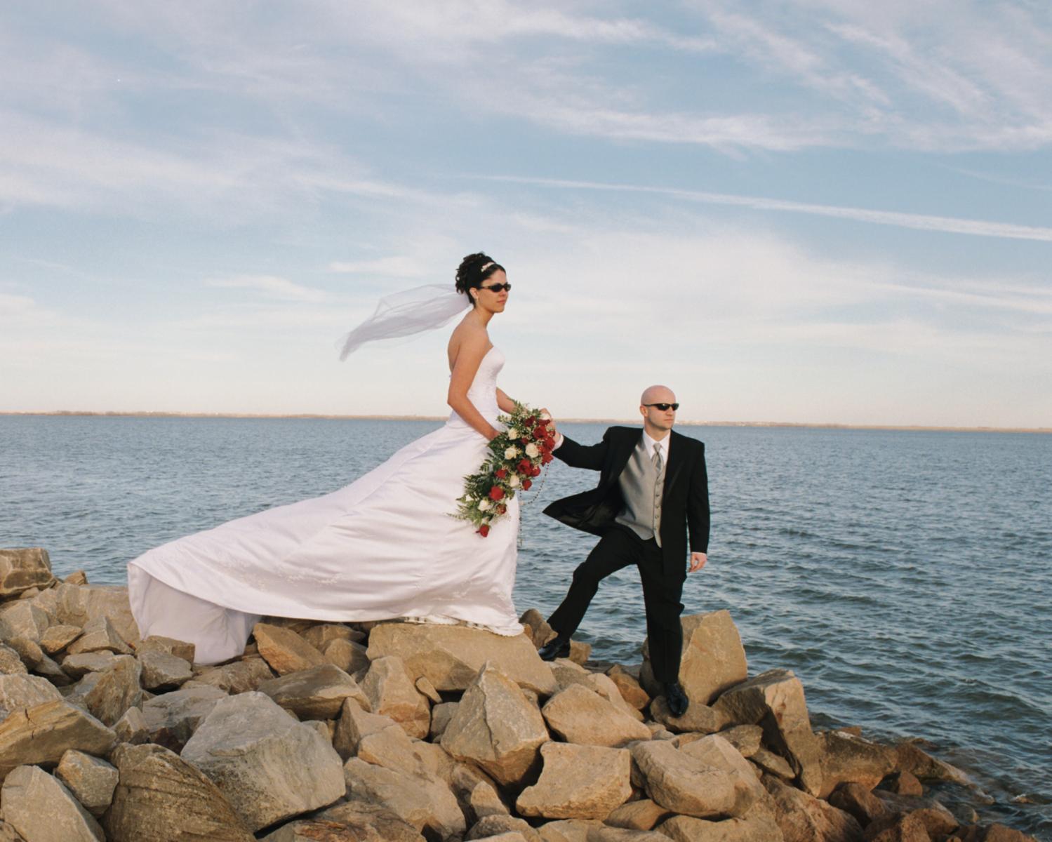 Chivalry is displayed in this charming wedding photograph on Cheney Lake in Kansas, by Robertsons' Warehouse Photography