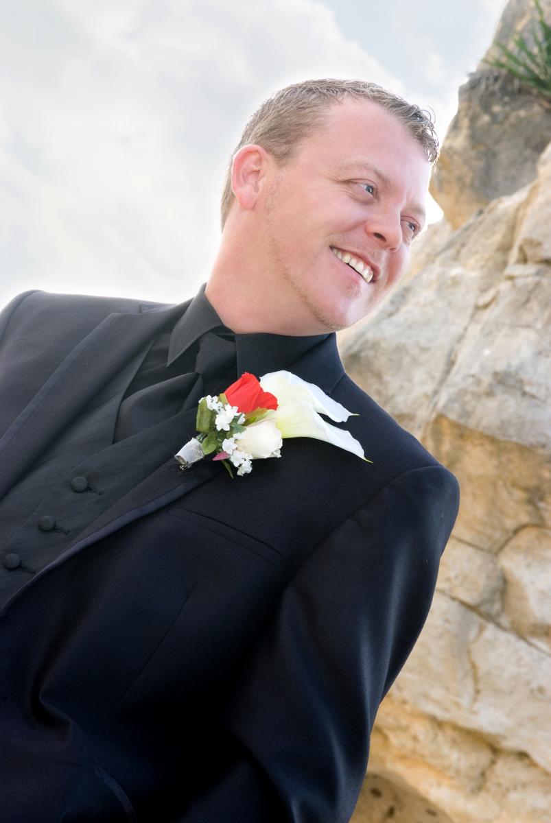 Low camera angle creates the impression this groom is to be looked up to, to be respected, by Robertsons' Warehouse Photography, Wichita, KS