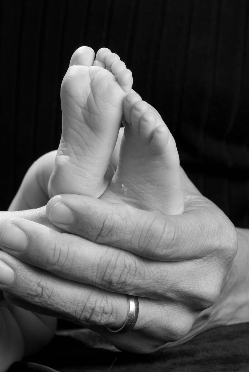 Baby's Tiny Toes Held by Dad in Photo by Robertsons' Warehouse Photography, Wichita, KS