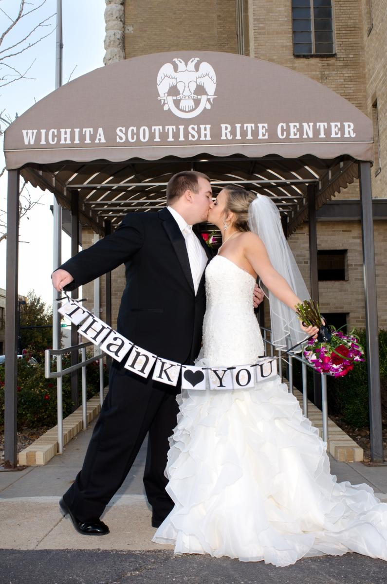 The kiss that says "Thank You" to all friends and family who shared the most important day of their lives, by Robertsons' Warehouse Photography, Wichita, KS