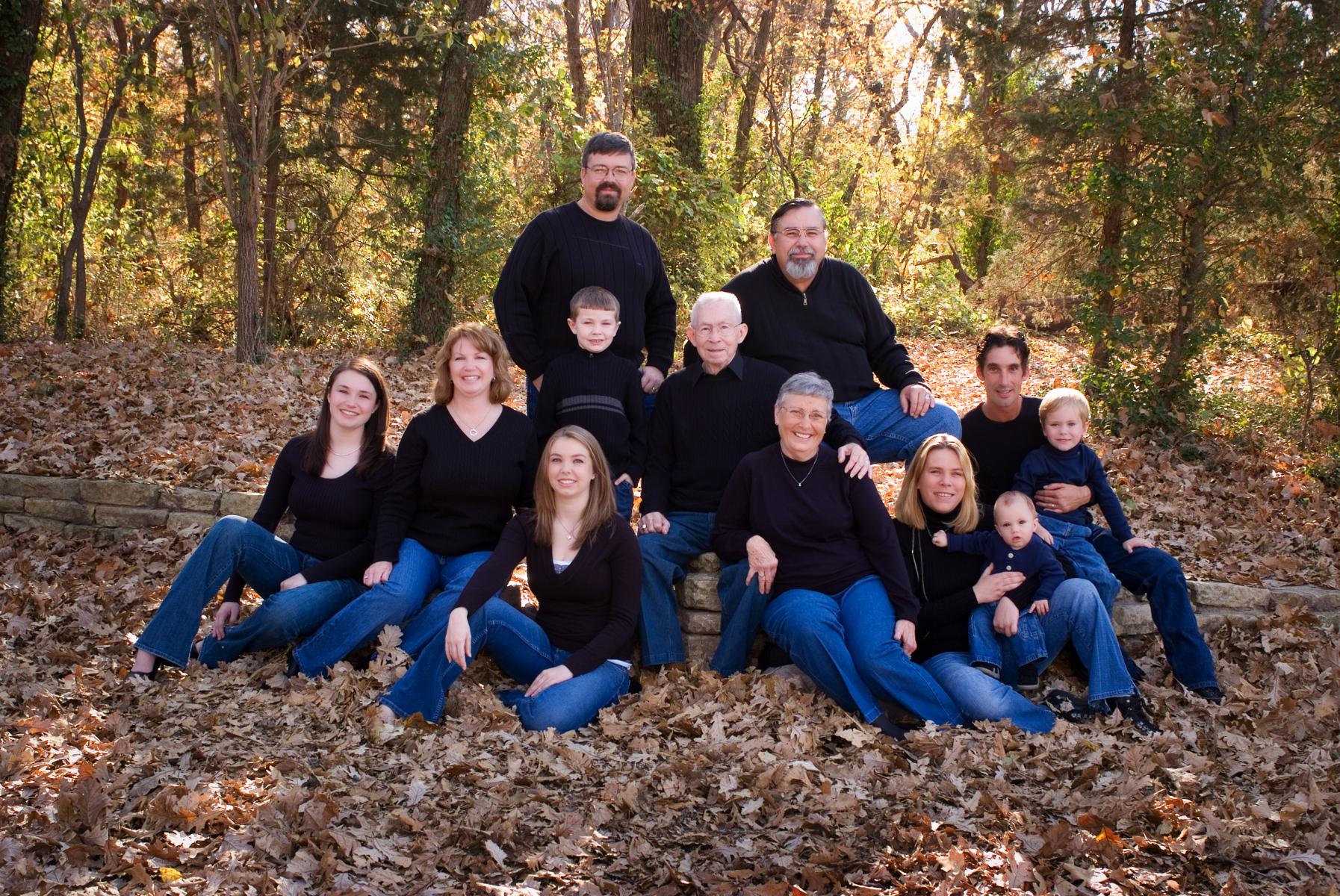 The Moyers nestled together next to a wooded area for their large family group photography, celebrating their 60th wedding anniversary, by Robertsons' Warehouse Photography, Wichita, KS